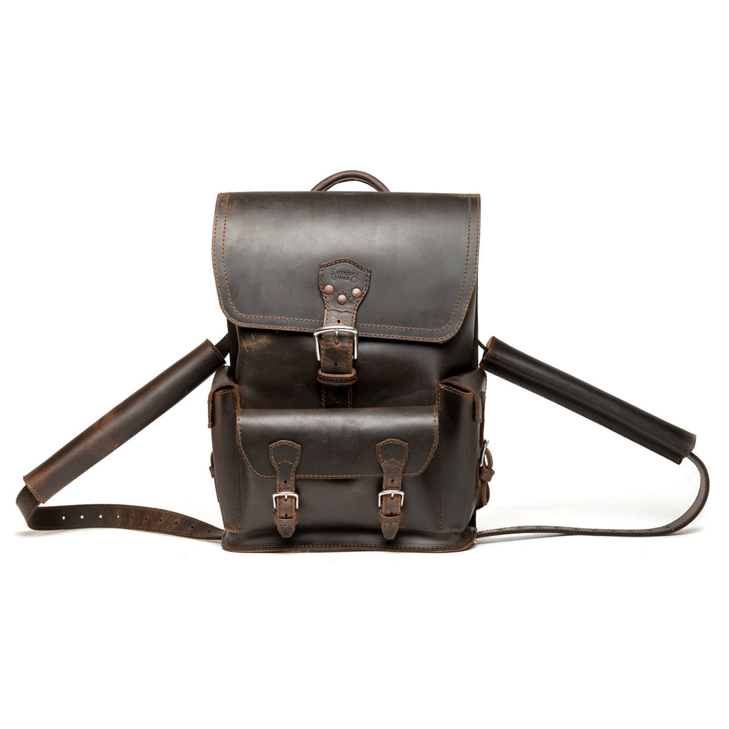 Thin Front Pocket Leather Backpack in Dark Coffee Brown, front view with buckled flap and front pocket
