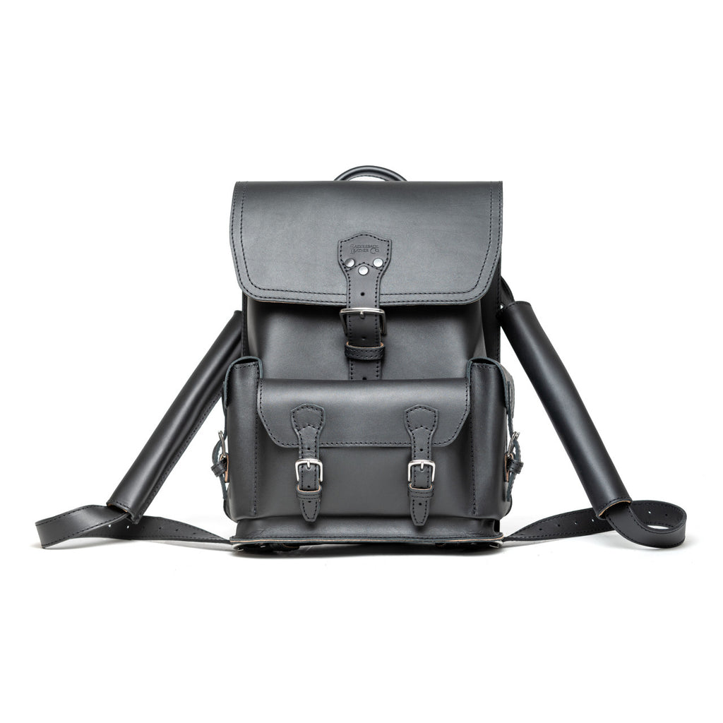 Thin Front Pocket Leather Backpack in Black, front view with buckled flap and front pocket