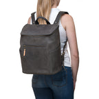All in One Leather Backpack in Black worn on the back of a woman in jeans, rear view