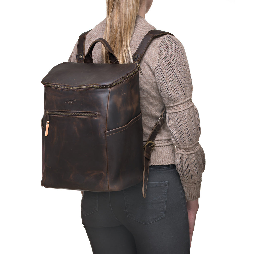 All in One Leather Backpack in Dark Coffee Brown worn by a woman in a knit sweater, rear angled view