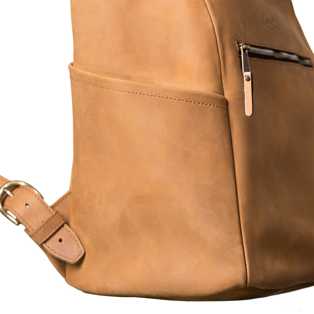 All in One Leather Backpack in Tobacco, close-up of side pocket, zipper pull and strap buckle