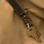 All in One Leather Backpack, close-up of the interior leather key strap and clip holding keys