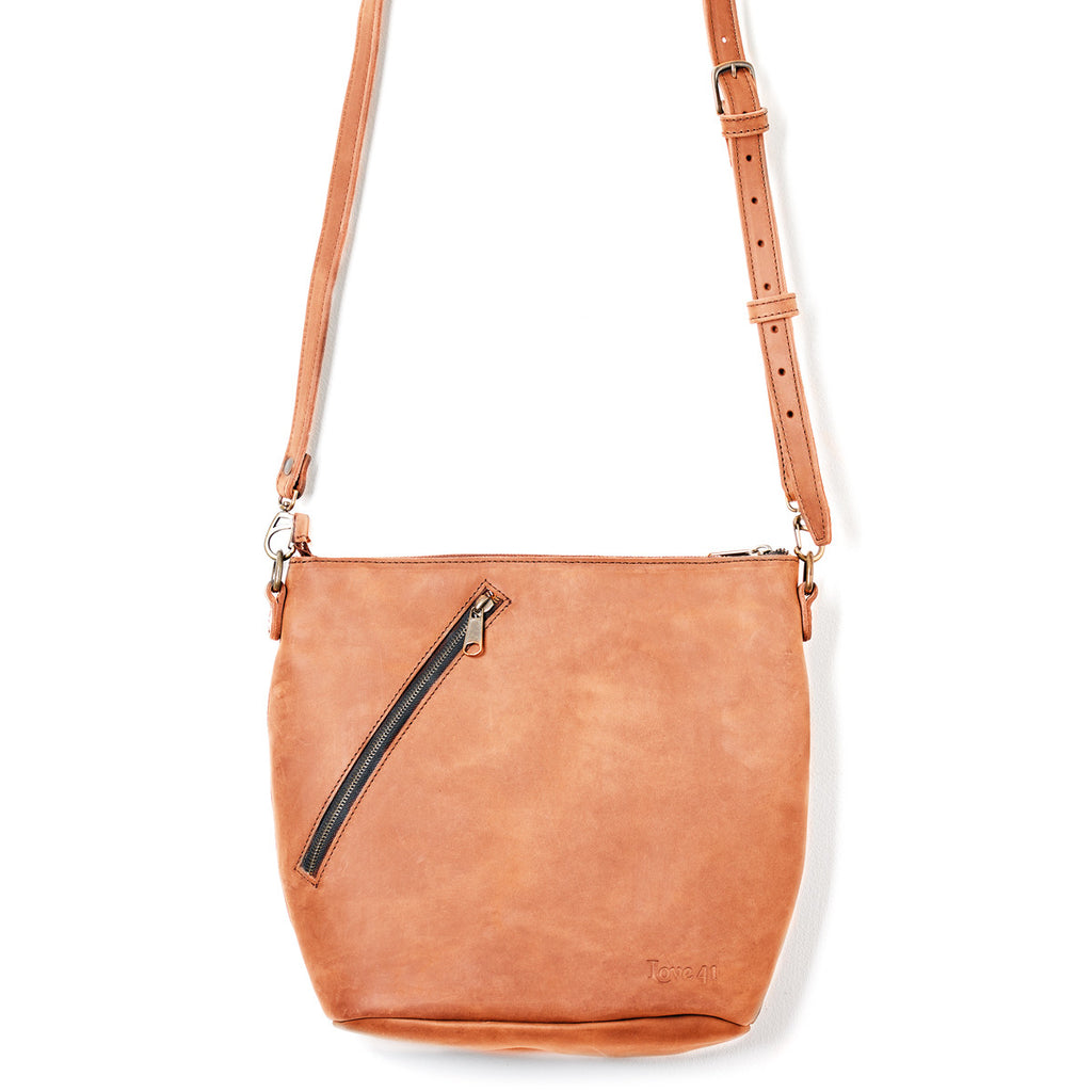 Crossbody Concealed Leather Bag in Tan, front view with diagonal zipper pocket and adjustable strap
