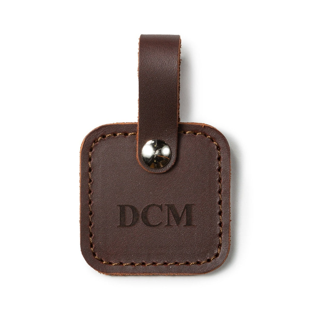 Leather Bag Tag in Chestnut with snap strap, personalized with an engraved DCM monogram