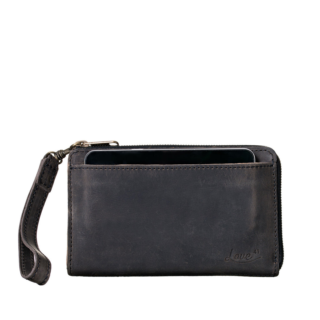 Medium Wristlet Leather Wallet in black, phone tucked in front slip pocket with wrist strap