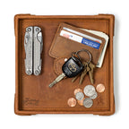The Leather Grandfather Valet Tray in Tobacco, top-down view holding a multi-tool, card wallet, keys and coins