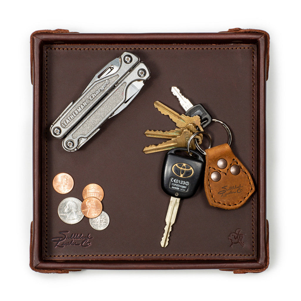 The Leather Grandfather Valet Tray in Chestnut, top-down view holding a multi-tool, keys, key fob and coins