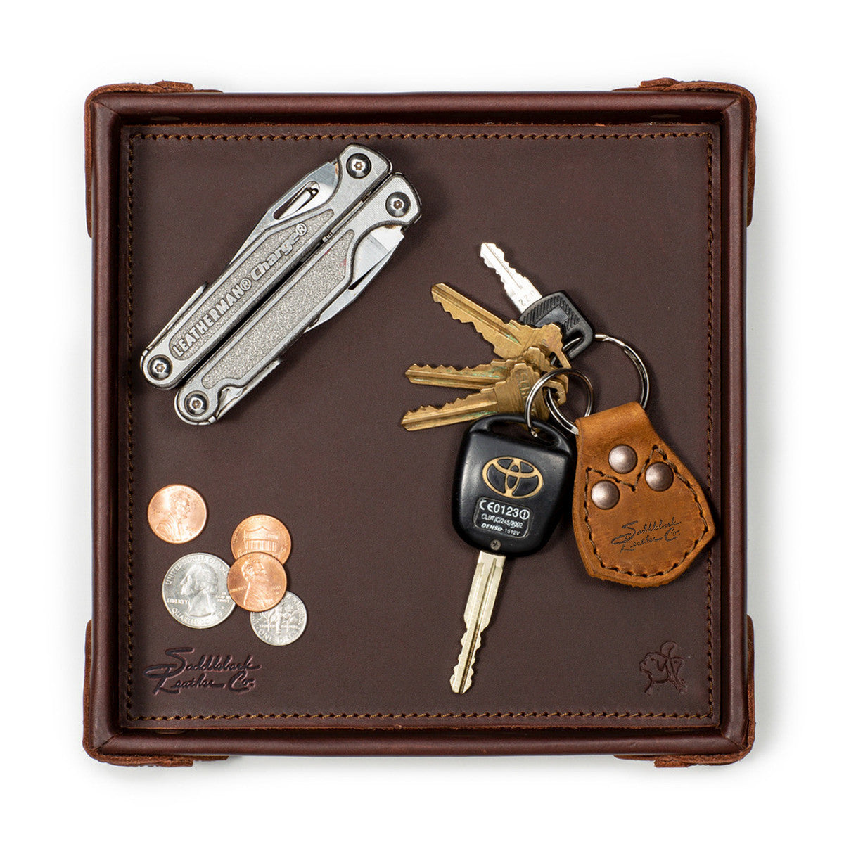 The Leather Grandfather Valet Tray in Chestnut, top-down view holding a multi-tool, keys, key fob and coins
