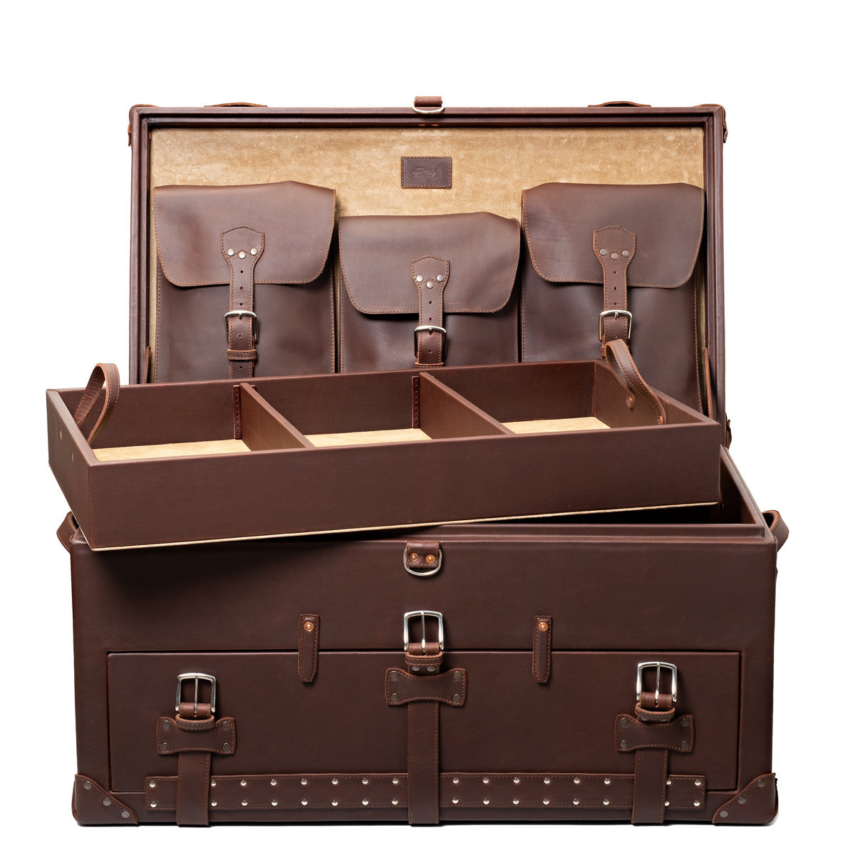 Leather Trunk in Chestnut, open with the empty divided tray lifted above the body and buckled lid pockets