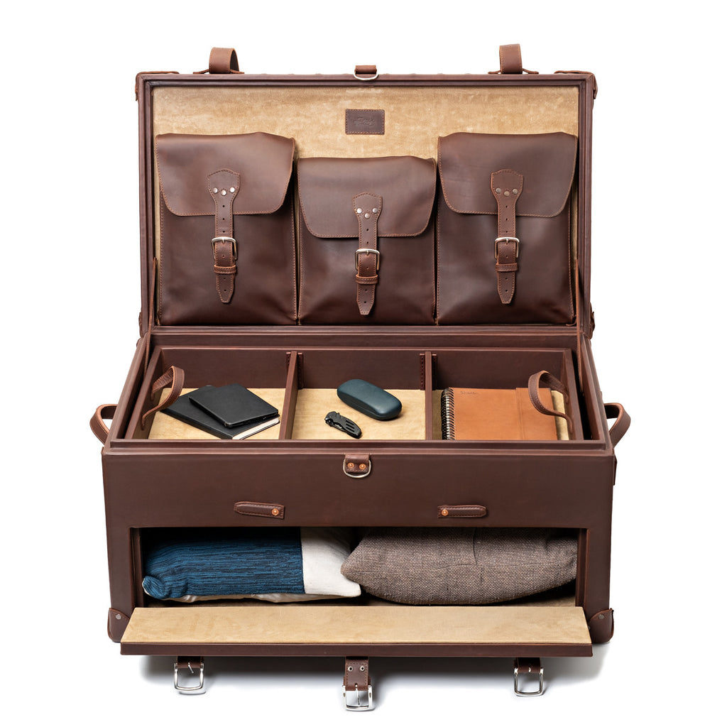 Leather Trunk in Chestnut, fully open with accessories in the top tray and sweaters in the front drawer