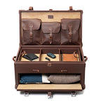 Leather Trunk in Chestnut, fully open with accessories in the top tray and sweaters in the front drawer