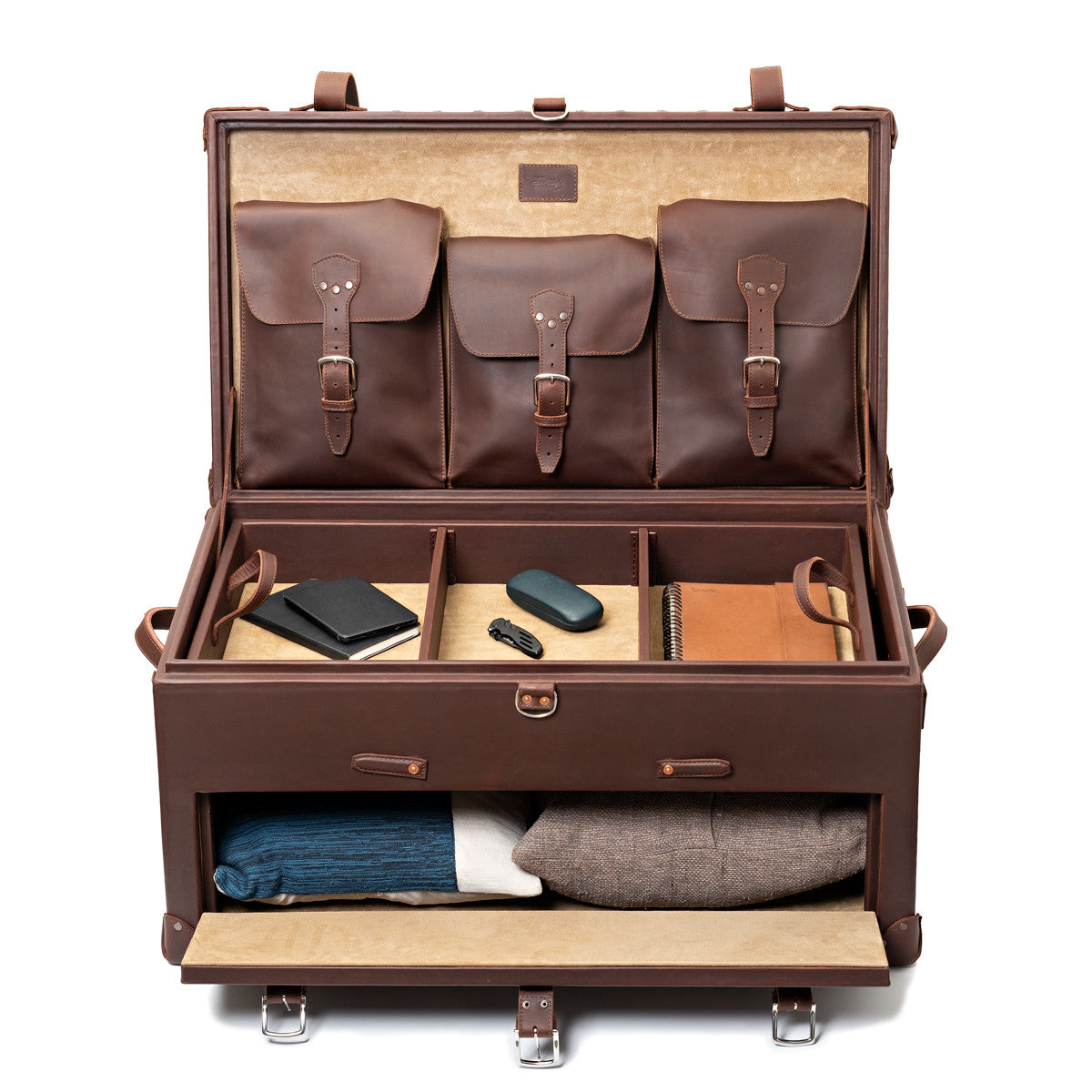 Leather Trunk in Chestnut, fully open with accessories in the top tray and sweaters in the front drawer