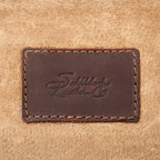 Leather Trunk, close-up of stitched leather patch with embossed Saddleback Leather Co. logo on the suede lining