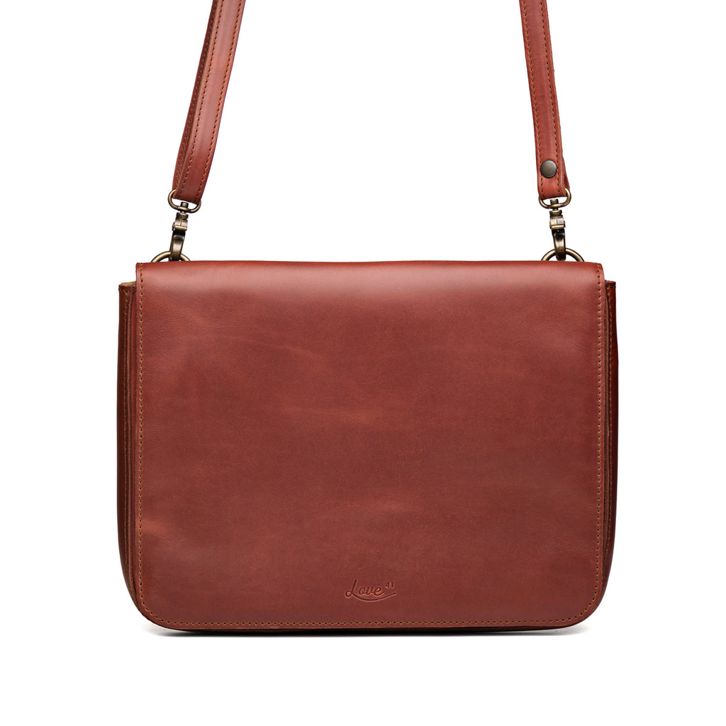 Magnetic Fold Over Bag Large in Chestnut, front view with fold-over flap, embossed logo and shoulder strap