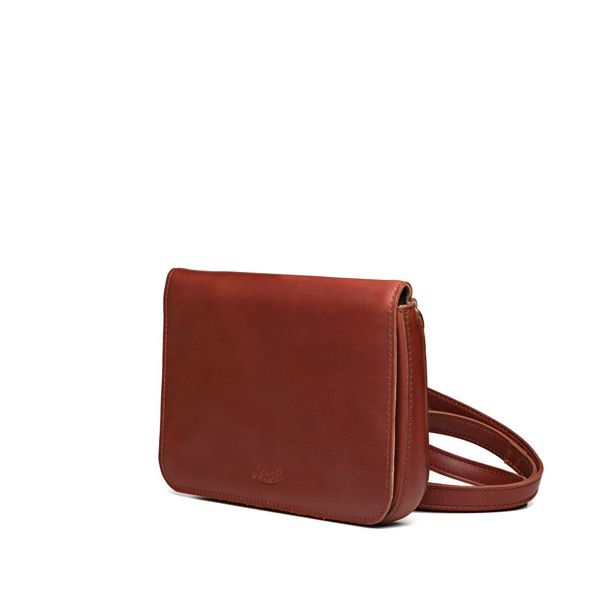 Magnetic Fold Over Bag Medium in Chestnut, angled side view with strap resting beside the bag