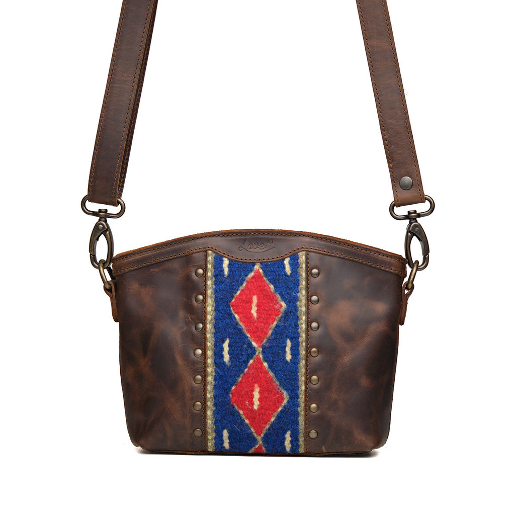 Lanita Small Crossbody in Dark Coffee Brown, front view with blue and red woven panel, studs and shoulder strap