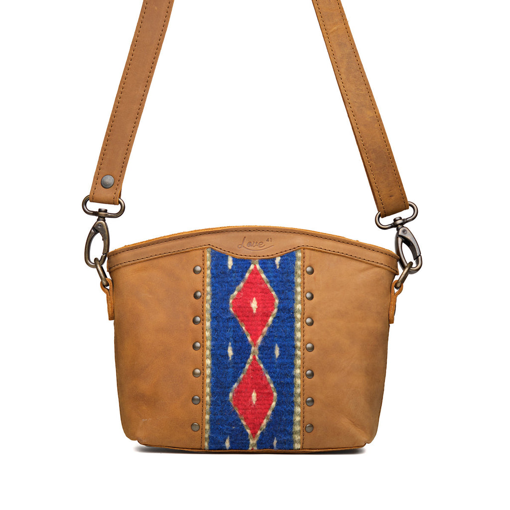 Lanita Small Crossbody in Tobacco, front view with blue and red woven panel, studs and shoulder strap