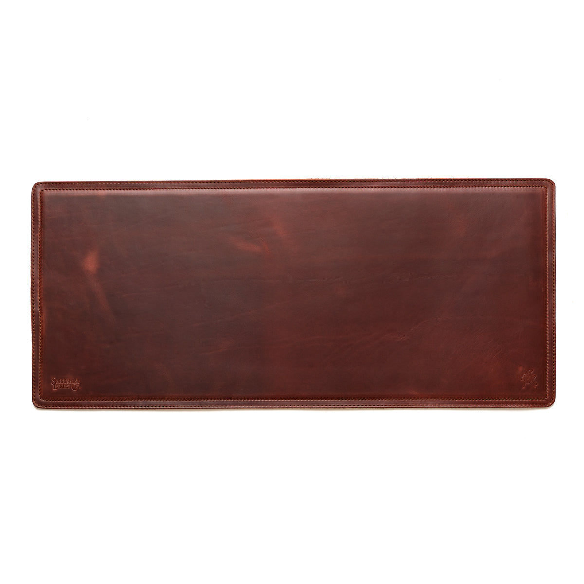 Long Desk Pad in Chestnut, empty top-down view showing stitched border and rounded corners