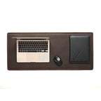 Long Desk Pad in Dark Coffee Brown styled as a workspace with a laptop, mouse and black notebook, overhead view
