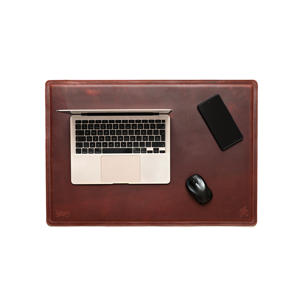 Desk Pad in Chestnut styled as a workspace with a laptop, phone and mouse, overhead view
