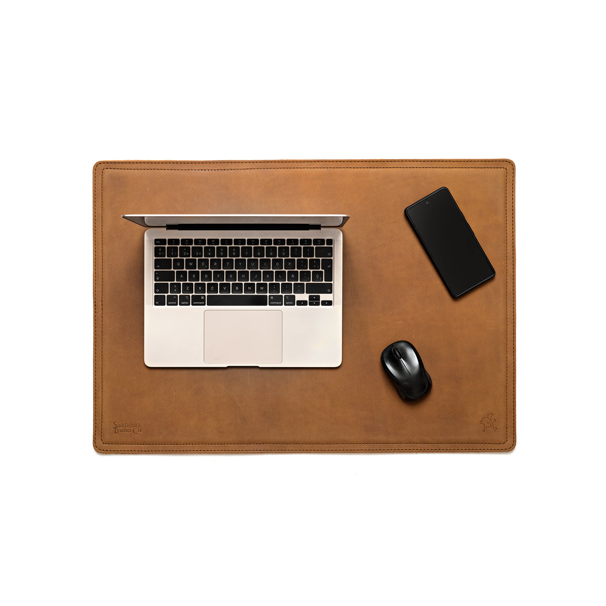 Desk Pad in Tobacco styled as a workspace with a laptop, phone and mouse, overhead view