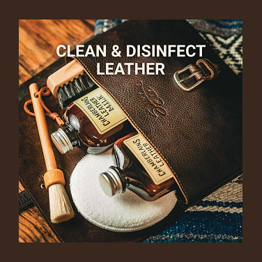 Clean & Disinfect Leather: two bottles of Chamberlain's Leather Milk, a brush and a round applicator pad on a dark leather portfolio