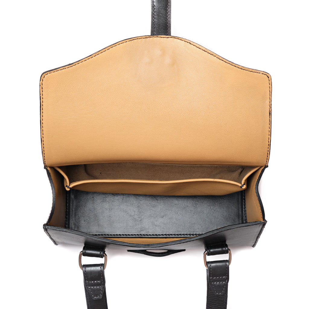 Double Handle Purse in Raven Black, top-down view with flap open showing the empty tan-lined interior