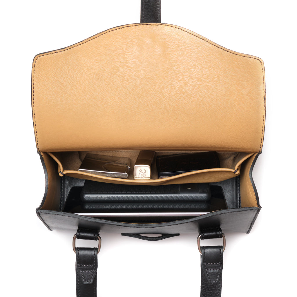 Double Handle Purse in Raven Black, top-down view with flap open showing the tan lining and contents