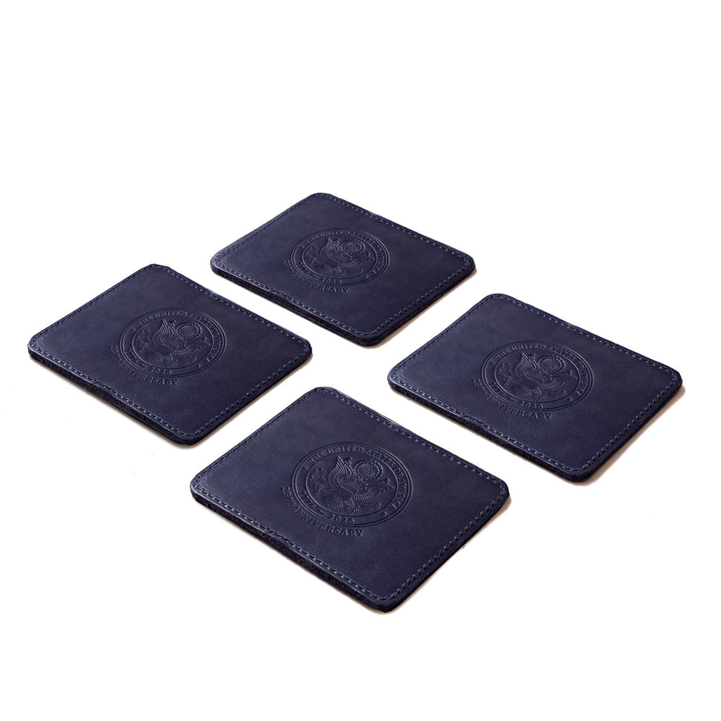 Saddleback Club Membership John Adams Leather Coaster Set in Blue and Red, four navy coasters with embossed seal laid out