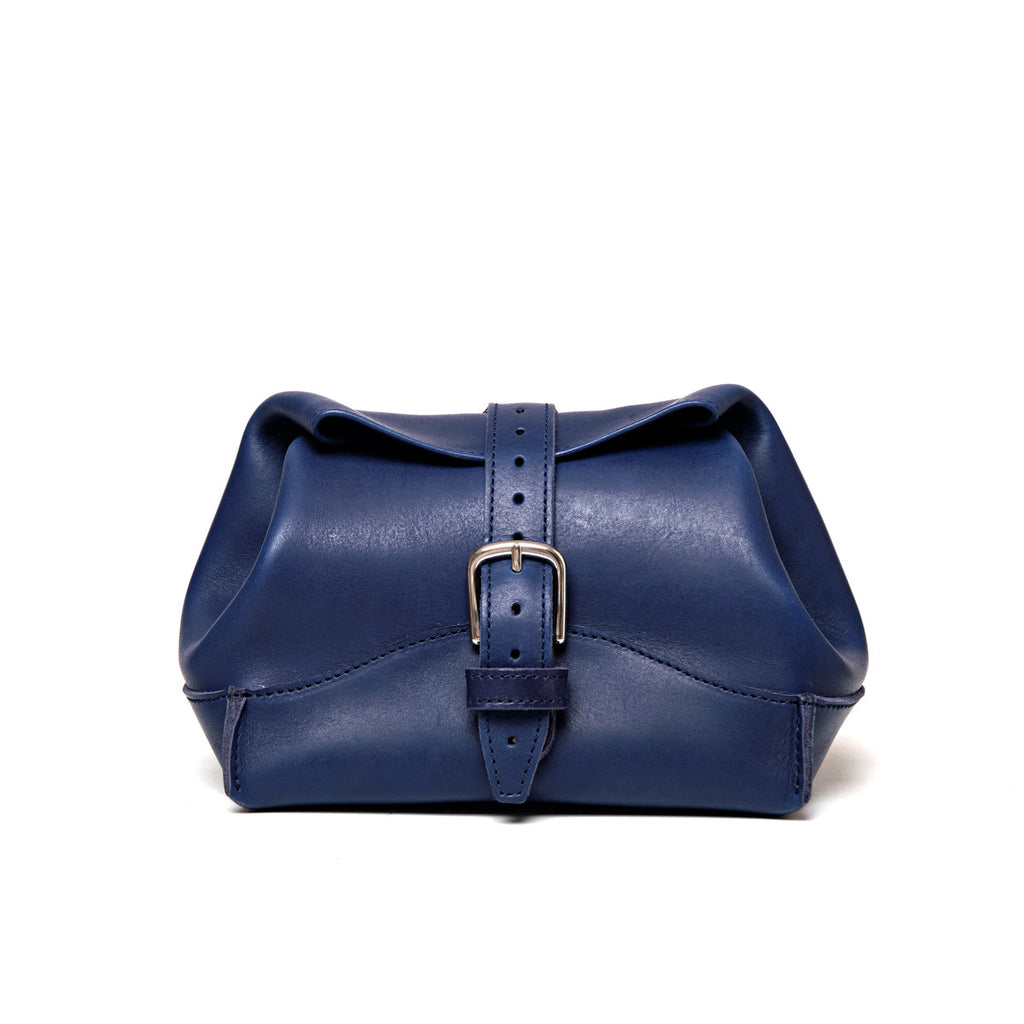 Saddleback Club Membership George Washington Leather Roll-Up Toiletry Bag in Blue, front view with buckle strap closure