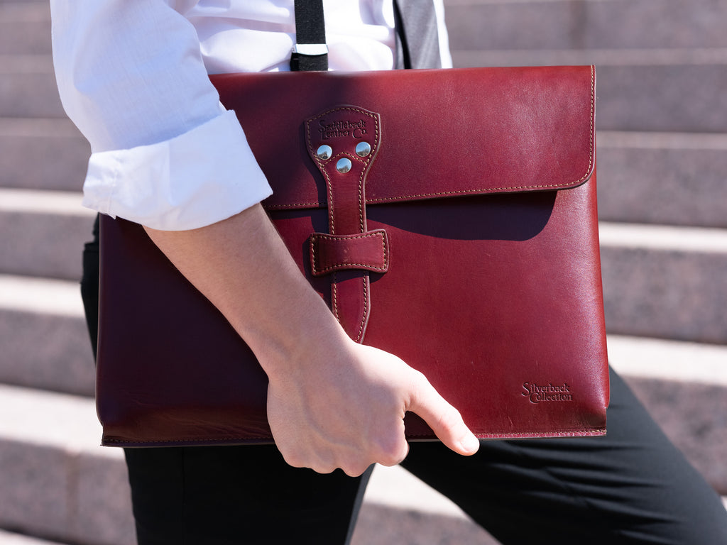 Silverback Document Holder in Oxblood, carried under the arm while walking up stone steps