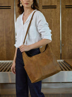 Women's Hobo Organizer Bag in Tobacco, worn crossbody over a white shirt and dark jeans