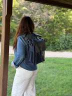 Saddleback Club Membership Paul Revere Leather Messenger Bag Backpack in Red, White and Blue, back view worn on a porch