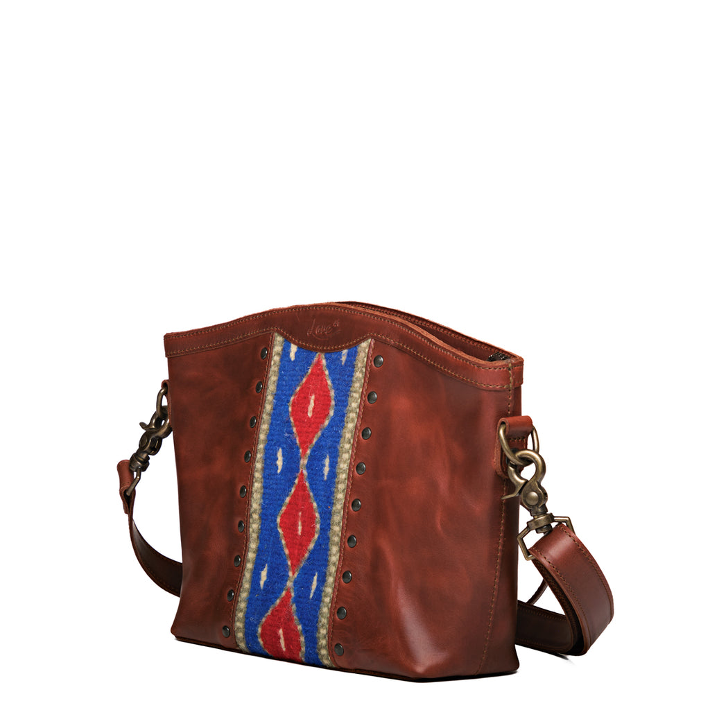 Lanita Medium Crossbody in Chestnut, angled front view with blue and red woven panel and stud trim