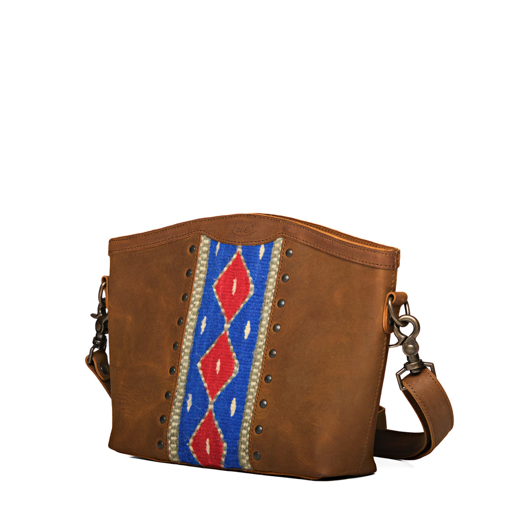 Lanita Medium Crossbody in Tobacco, angled front view with blue and red woven panel and stud trim