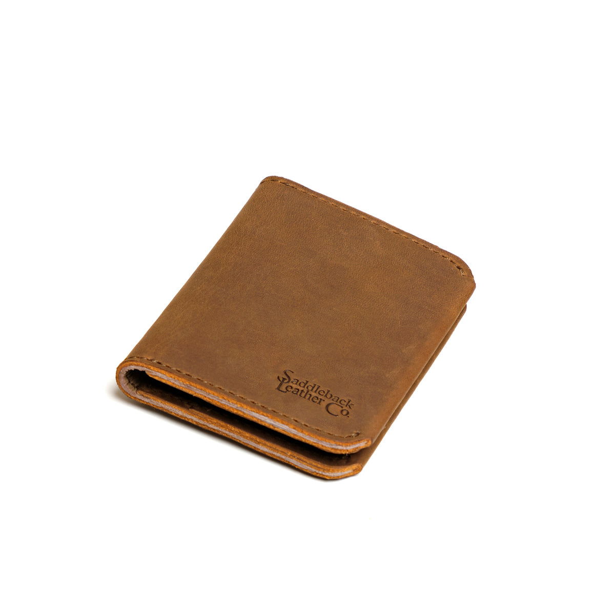 Large Bifold Wallet in Tobacco, closed and angled showing the stitched spine and embossed logo
