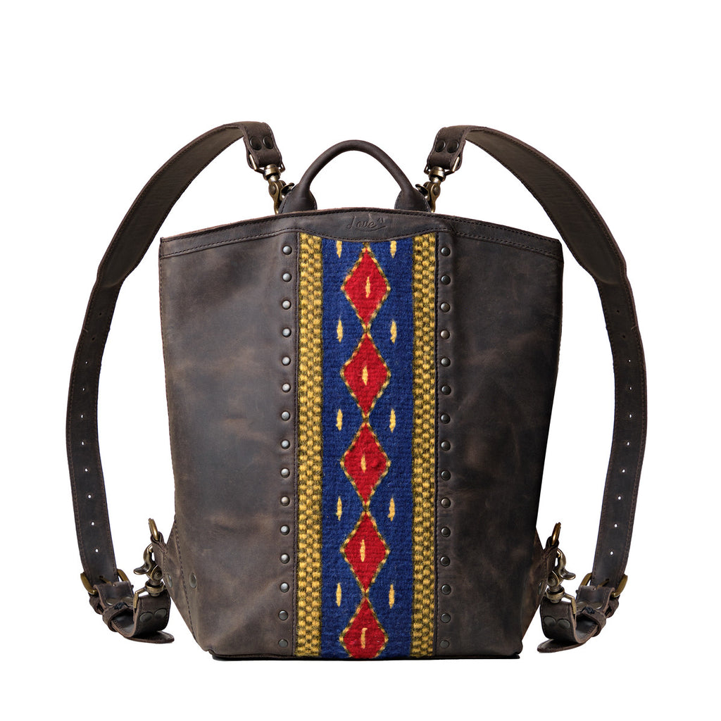 Lanita Leather Backpack in charcoal gray, front view with blue and red woven panel, studs and shoulder straps