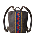 Lanita Leather Backpack in charcoal gray, front view with blue and red woven panel, studs and shoulder straps