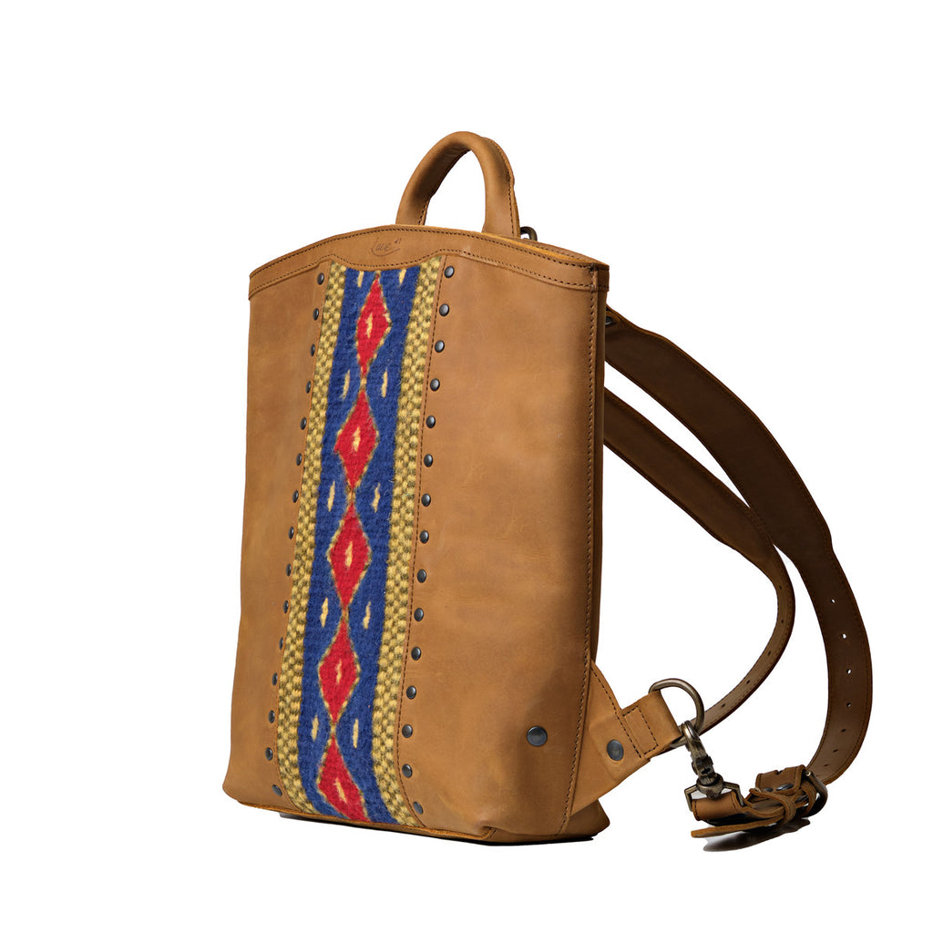 Lanita Leather Backpack in Tobacco, angled side view with woven panel and shoulder strap