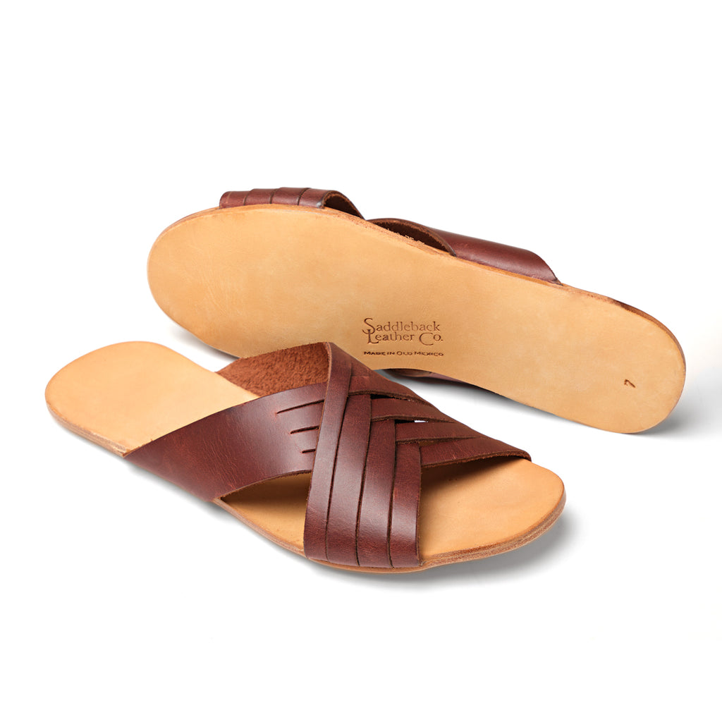 Martha Sandals in Chestnut, one sandal upright and one showing the sole with stamped logo