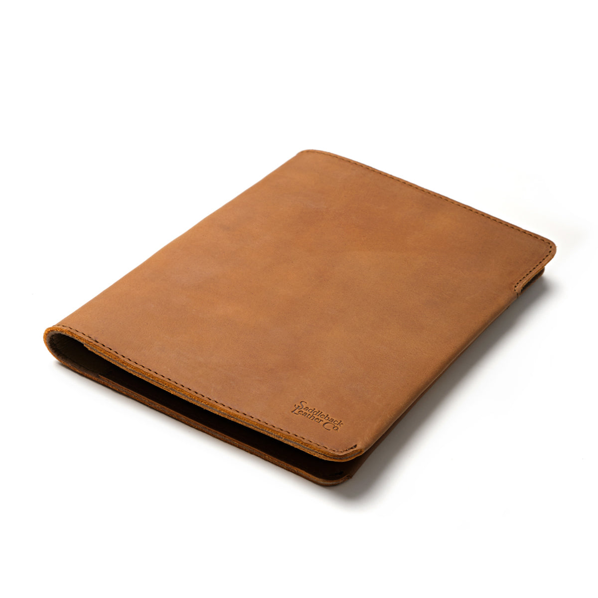 New Design Medium Portfolio in Tobacco, closed and angled showing the stitched edges and debossed logo