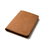 Medium Moleskin Cover in Tobacco, closed and angled showing stitched edges and debossed logo