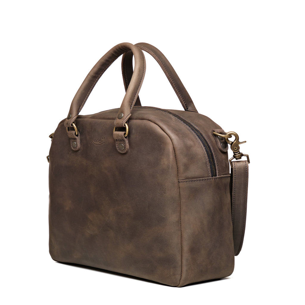 Professional Leather Satchel in Black, angled side view showing the zipper and side pocket