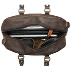 Professional Leather Satchel in Black, top view unzipped with a laptop, notebook and sunglasses inside