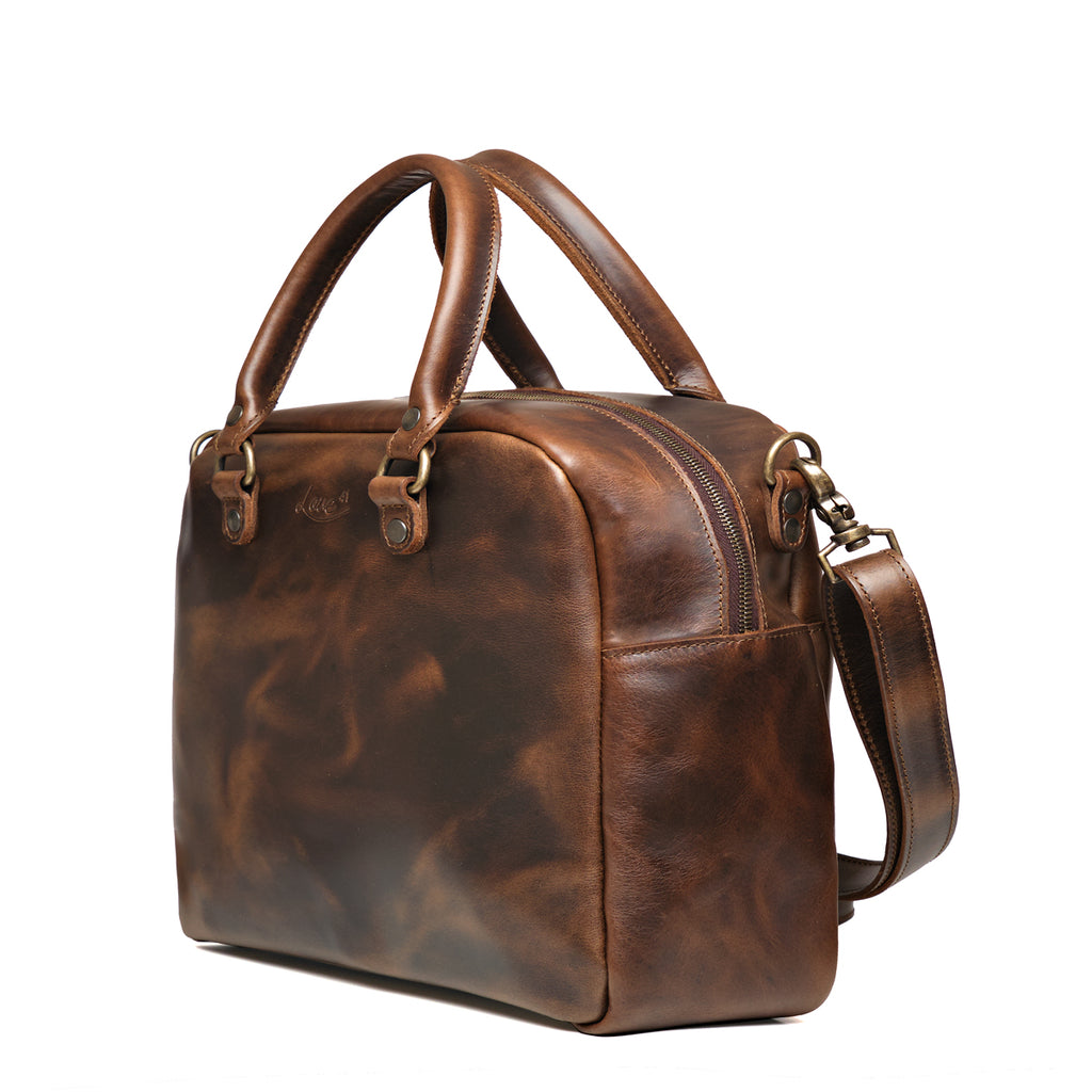 Professional Leather Satchel in Dark Coffee Brown, angled side view showing the zipper and side pocket