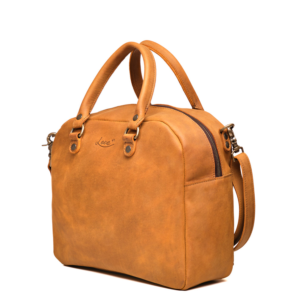 Professional Leather Satchel in Tobacco, angled side view showing the zipper and side pocket