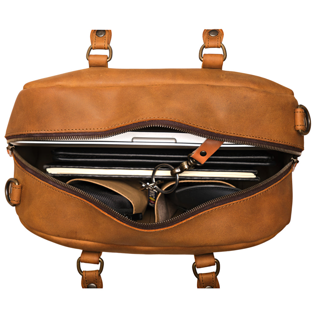 Professional Leather Satchel in Tobacco, top view unzipped with a laptop, notebook and sunglasses inside