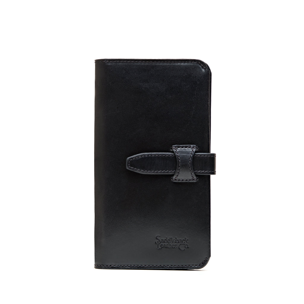 Big Wallet in Raven Black, closed front view with strap closure and debossed Saddleback Leather Co. logo