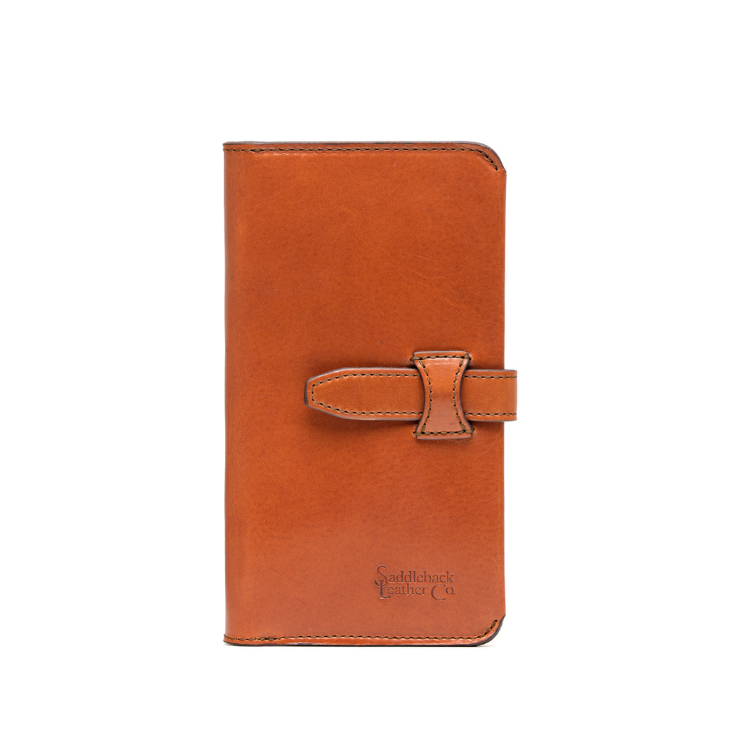 Big Wallet in English Tan, closed front view with strap closure and debossed Saddleback Leather Co. logo