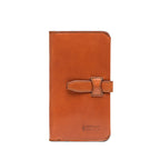 Big Wallet in English Tan, closed front view with strap closure and debossed Saddleback Leather Co. logo